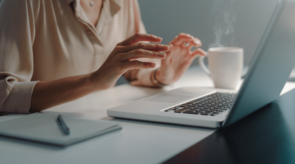 Hands hovering over a keyboard